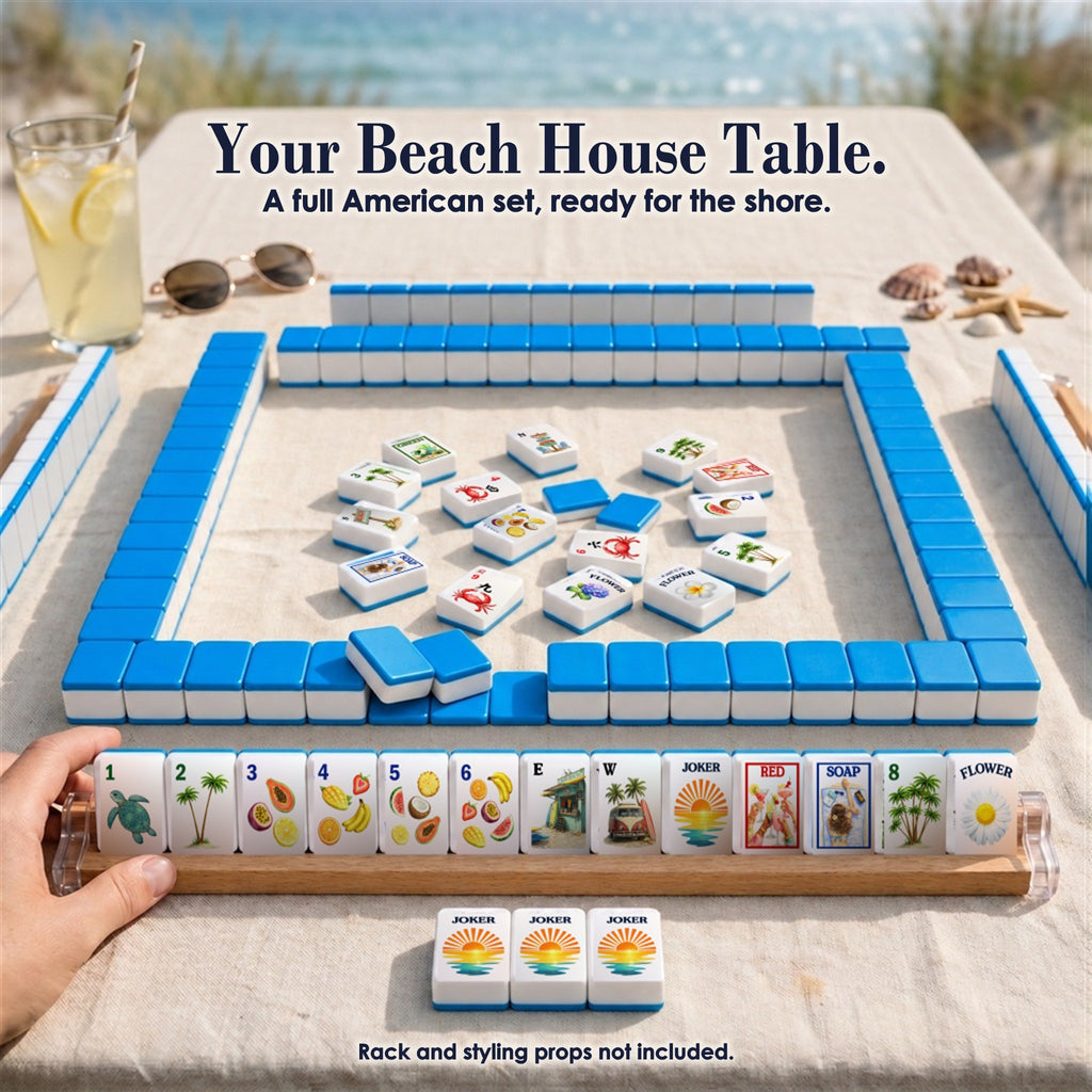 Beach mahjong game by the dunes: blue-backed tile walls, face-up tiles in the center, a rack of 13 tiles, three Jokers