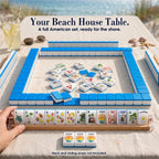 Beach mahjong game by the dunes: blue-backed tile walls, face-up tiles in the center, a rack of 13 tiles, three Jokers