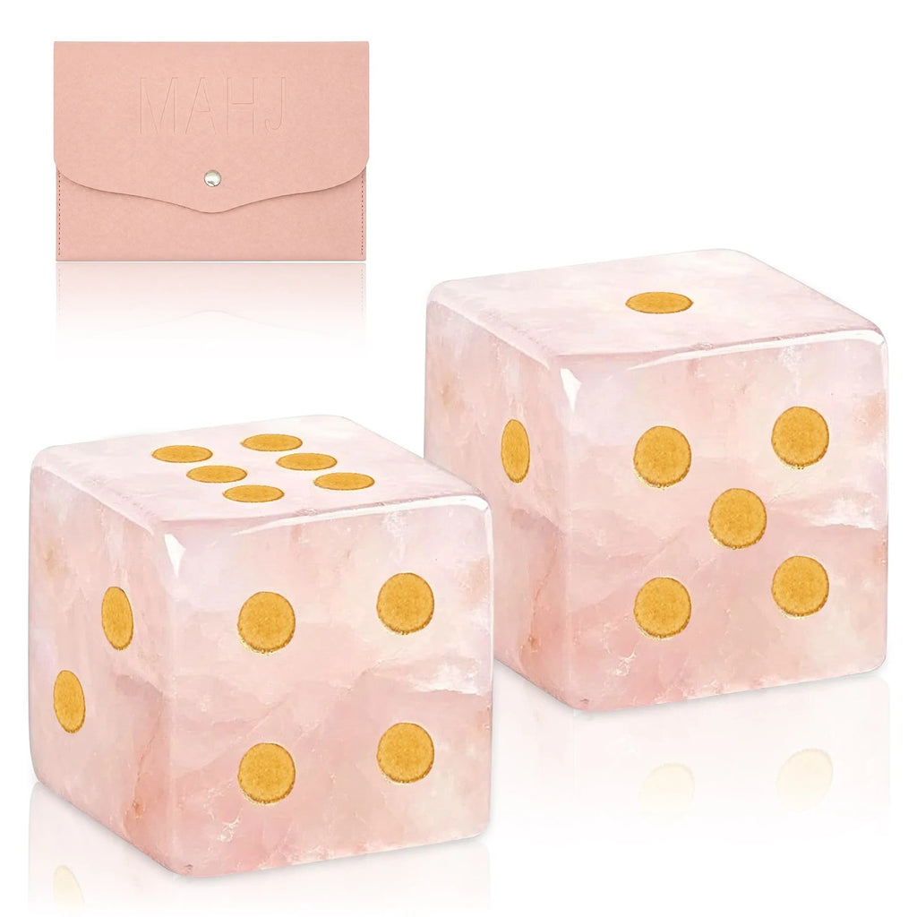 Two pink marbled dice with gold pips in front of their pink pouch
