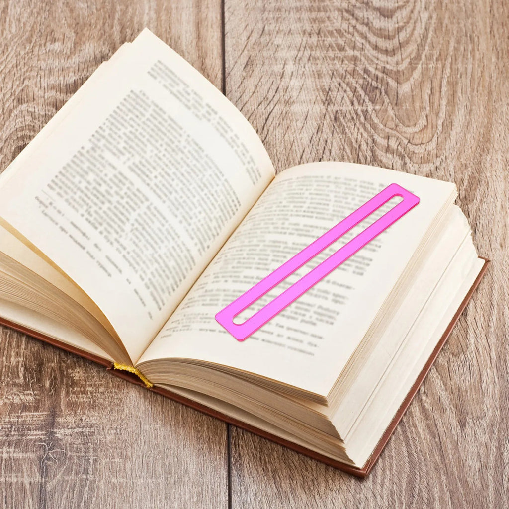 A pink line finder laid across one line of an open book