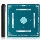 Teal square mahjong mat marked with the four winds, beside its black carry bag