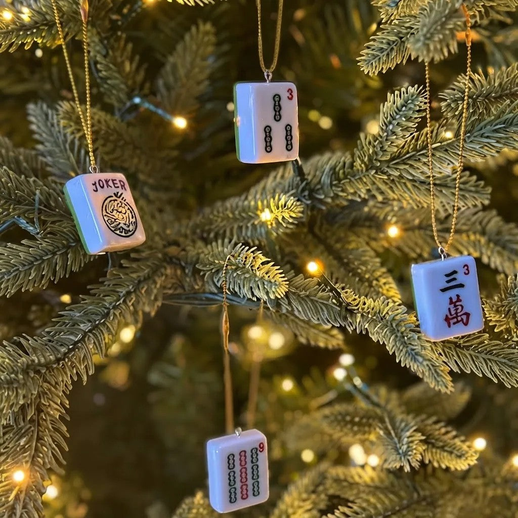 Mahjong tile ornaments hanging on a lit tree