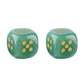 Two green stone dice with gold pips