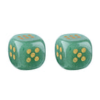 Two green stone dice with gold pips
