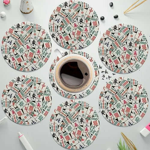 Mahjong tile print coasters spread on a table with a coffee cup
